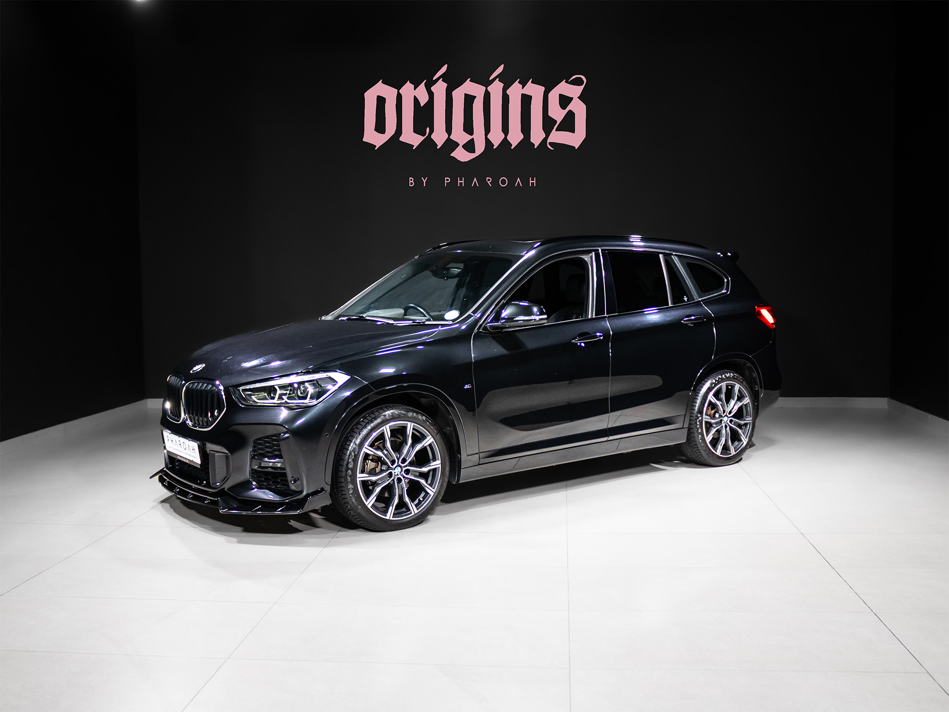 luxury vehicles black bmw suv in a showroom, logo 'origins by pharaoh' on the back wall in pink text. explore this 2020 bmw for sale in south africa at pharoah group, sandton. premium luxury vehicle with finance options, trade-ins, and nationwide delivery available.  # » high end cars » pharoah cars